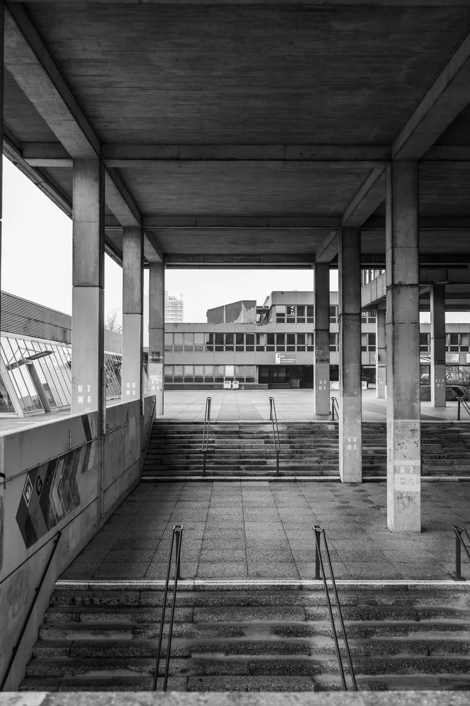 Concrete stairs and a brutalist building, in black and white.